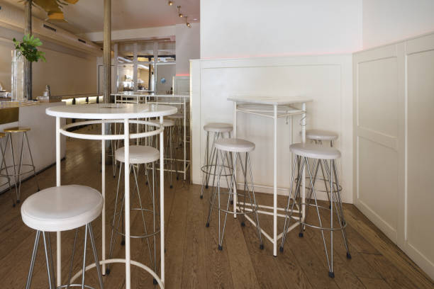 istock Circular high tables with matching white upholstered stools in a restaurant lounge 1486081194