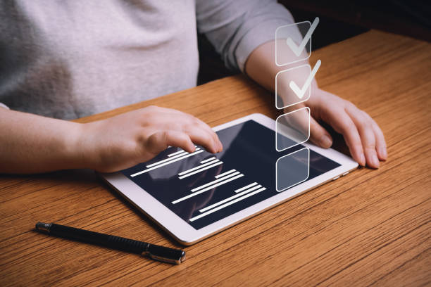 Woman use tablet marking check boxes. Successful completion of business tasks.
