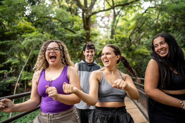 istock Friends walking and dancing in the park 1486081449