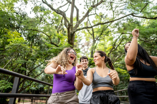istock Friends walking and dancing in the park 1486081473