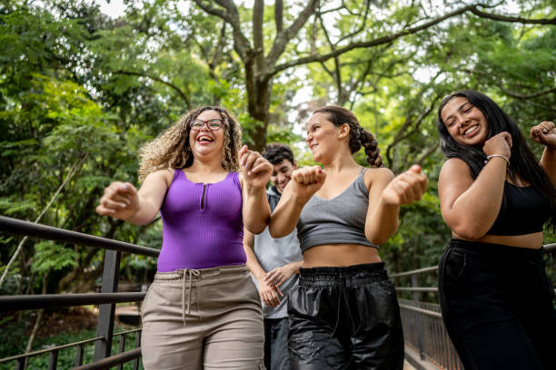 Friends walking and dancing in the park