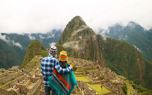 Couple being impressed with the incredible view of Machu Picchu ancient Inca citadel, UNESCO world heritage site in Cusco Region, Peru, South America, ( Self Portrait )
