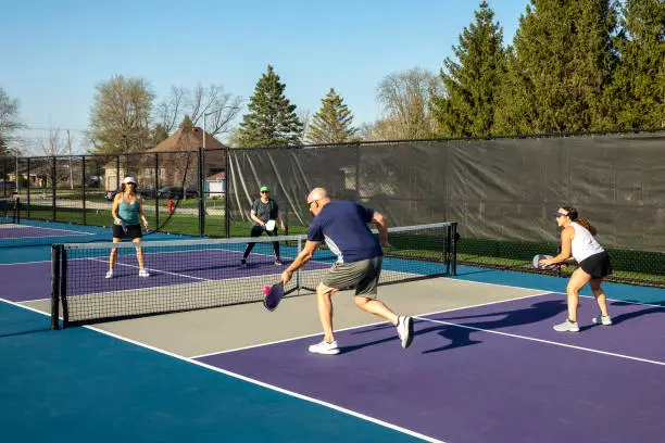 Photo of Male Pickleball Player Returning a Volley