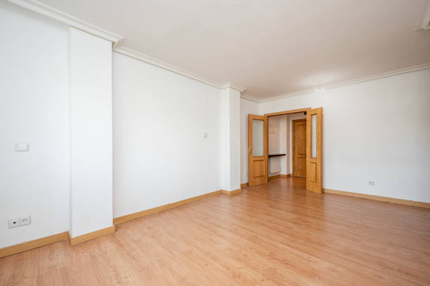 istock Large empty room with light oak wood floors and doors of the same material 1486089404