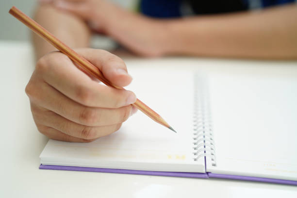 istock Asian teenage student write homework, study lesson for exam online learning education. 1486091735