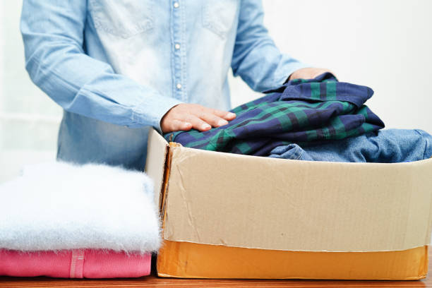 istock Clothes donations in cardboard box for volunteer. 1486091762
