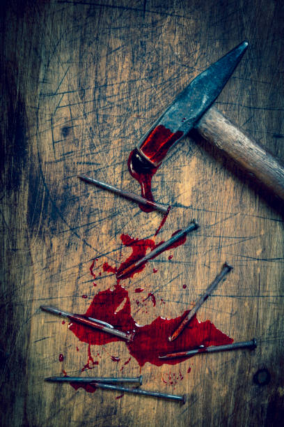 istock hammer and bloody nails on a wooden 1486092590