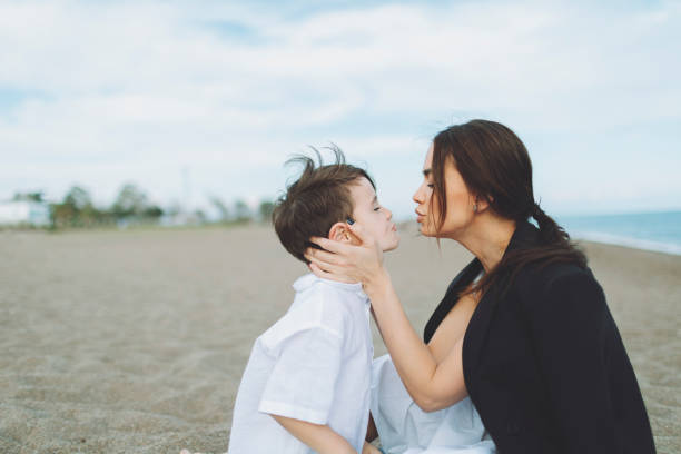 istock Mother and son having fun at the beach and embracing 1486093113