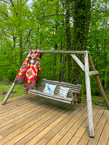 An outdoor porch swing on a summer day in the Ozark Mountains.
