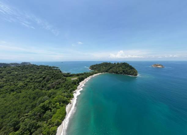 Aerial view of the green shoreline and turquoise ocean. Manuel Antonio National Park, Costa Rica. An aerial view of the green shoreline and turquoise ocean. Manuel Antonio National Park, Costa Rica. manuel antonio national park stock pictures, royalty-free photos & images