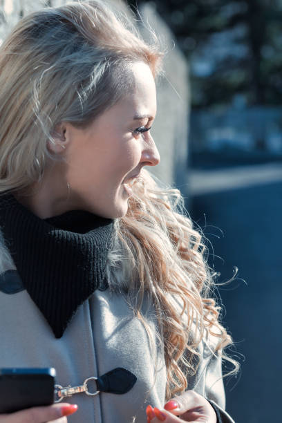 istock Curly blonde tourist at phone, perfect makeup 1486097874