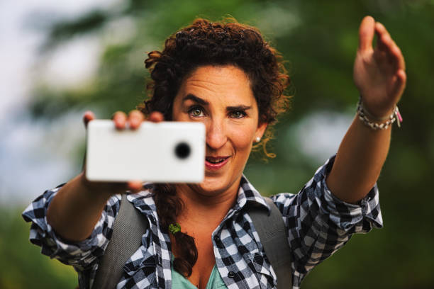 frau fungiert als fotografin mit handy - airport check in counter stock-fotos und bilder