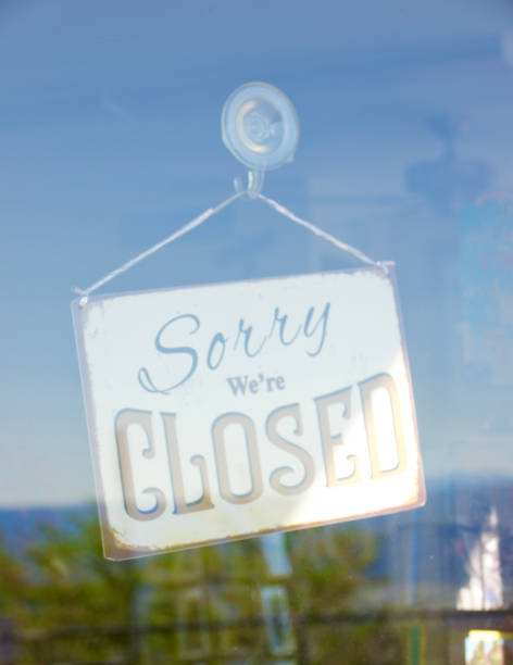 istock Business closed sign visible through the window 1486102167