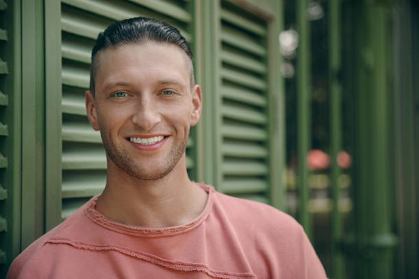 istock Handsome young man in stylish outfit near shutters outdoors, space for text 1486104023