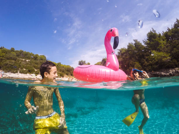 istock Children Having Fun With Inflatable Pelican 1486105687