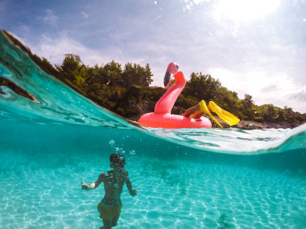 istock Children Having Fun With Inflatable Pelican 1486105710