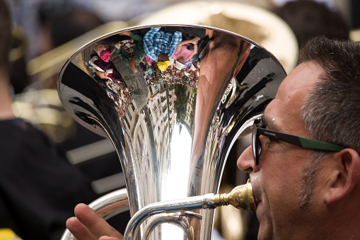 04-22-2023 Alcoy, Spain. Musician with reflections in the euphonium in the Moors and Christians parade