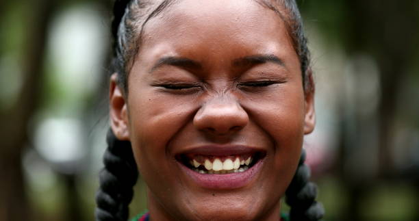 istock Mixed race black girl laughing outdoors looking at camera 1486108692