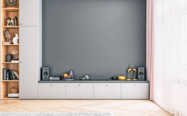 Front view of a modern living room with an empty space for TV on a cabinet stock photo