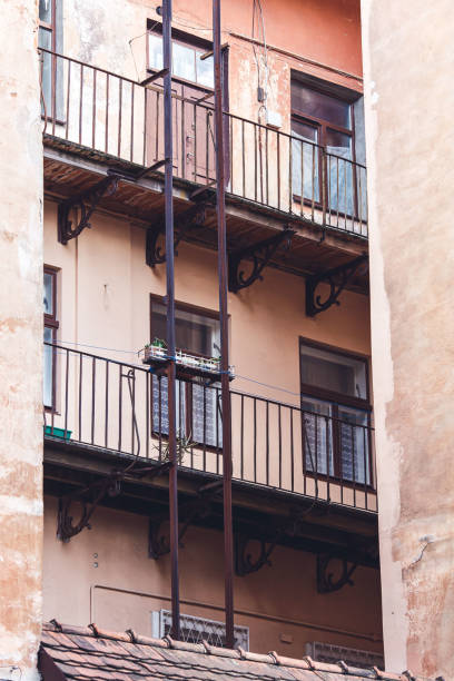 istock Balconies and iron staircase of old building. Old architecture 1486112796