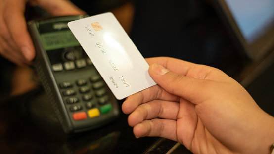 Woman hand making contactless payment with credit card