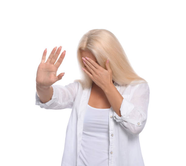 istock Embarrassed woman covering face with hand on white background 1486113670