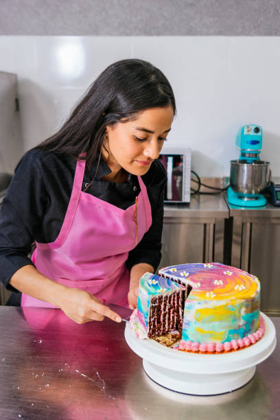 istock Pastry Chef Cutting a Slice of Freshly Made Cake 1486113878