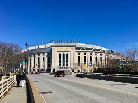 Yankee Stadium viewed while walking by foot from the Macombs Dam Bridge on a sunny day in March