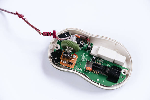 Disassembled computer mouse on white background. Gadget repair. Microchip in old computer hardware. Broken optical mouse. Copy space.