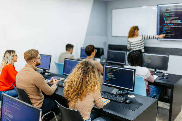 istock Mid Adult Female Teacher Teaching A Programing Class 1486115322