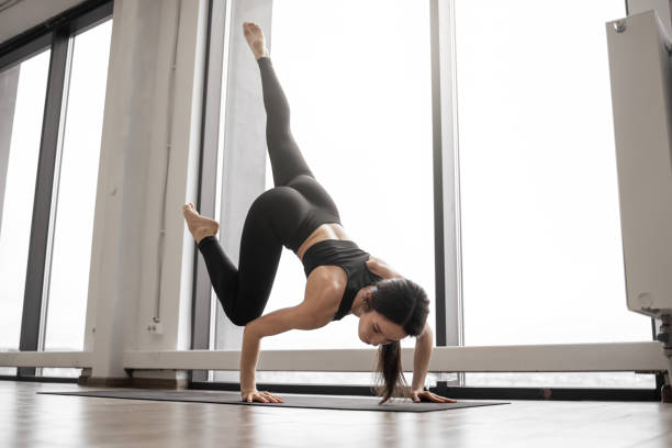 istock Strong woman doing power yoga during training indoors 1486120368