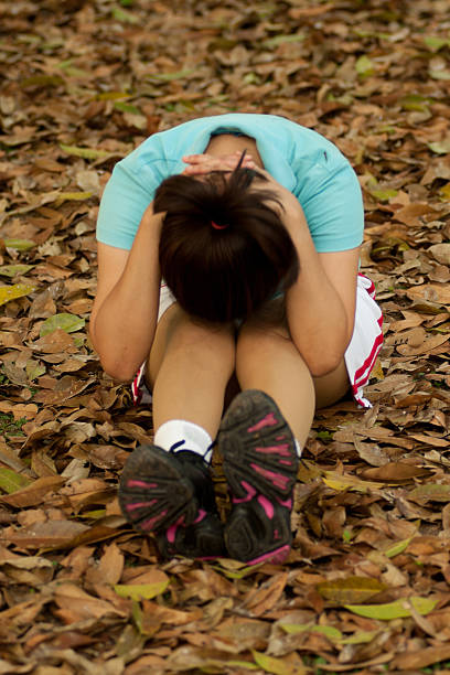 istock Thai woman exercise on ground in the park . 148612066