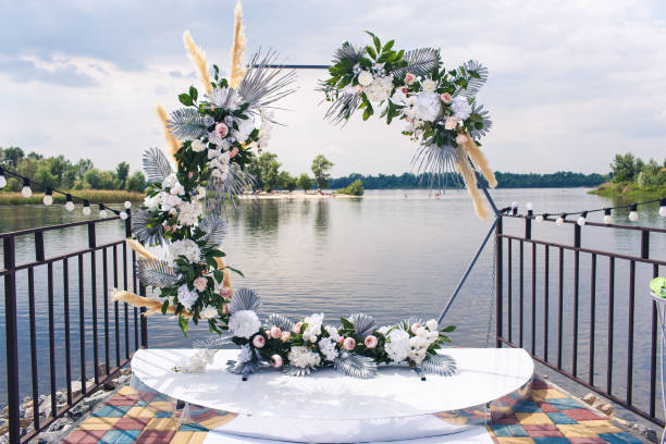 istock hexagonal wedding arch decorated with artificial flowers on the pier. wedding decor by the river 1486127112