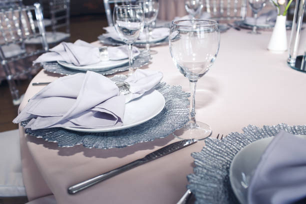 istock Elegant dining table setting with purple napkins 1486127137