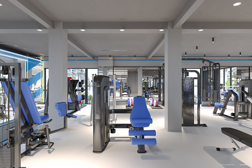 Modern GYM With Dumbbells, Exercise Bike,Barbell, And Sports Equipments .Healthy Lifestyle Concept.