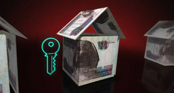 Egyptian Pound 100 EGP money banknotes paper house on the table. Egypt currency notes 3D illustration concept of home mortgage loan, costs, liabilities and real estate financing.