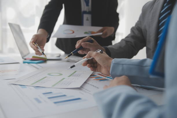 istock Financial analysts analyze business financial reports on a digital tablet planning investment project during a discussion at a meeting of corporate showing the results of their successful teamwork. 1486133371