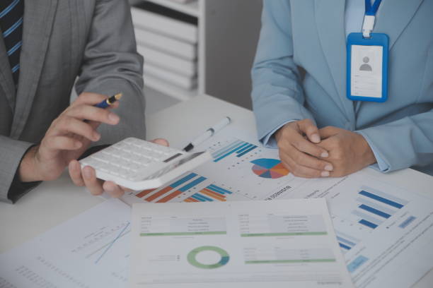 istock Financial analysts analyze business financial reports on a digital tablet planning investment project during a discussion at a meeting of corporate showing the results of their successful teamwork. 1486134021