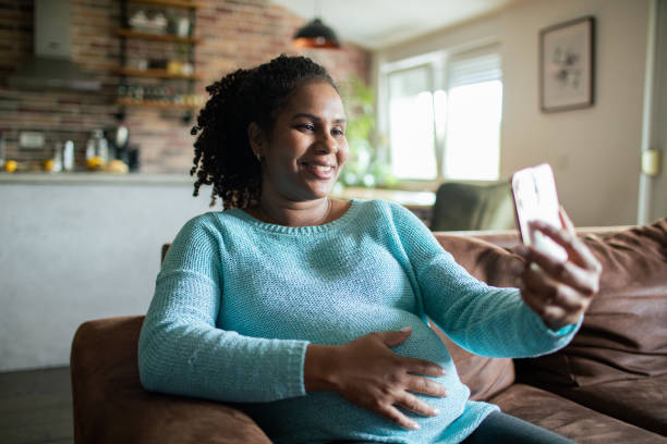 istock Young pregnant woman using a smart phone at home 1486136958