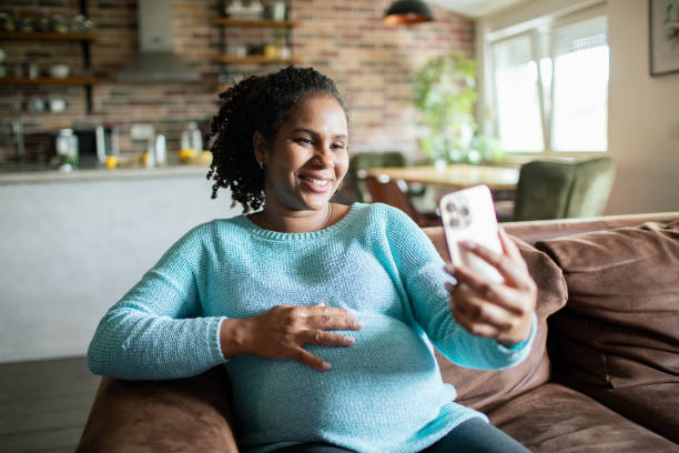 istock Young pregnant woman using a smart phone at home 1486137783