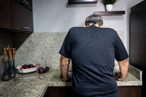 Senior man worried on the kitchen counter at home