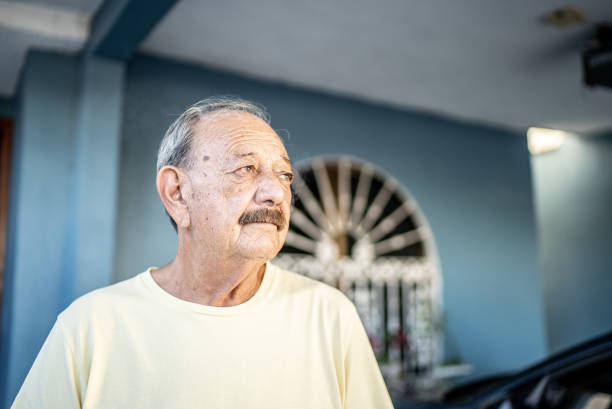 Senior man looking away contemplating at home