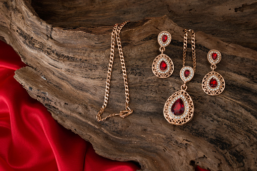 earrings necklace on wooden background