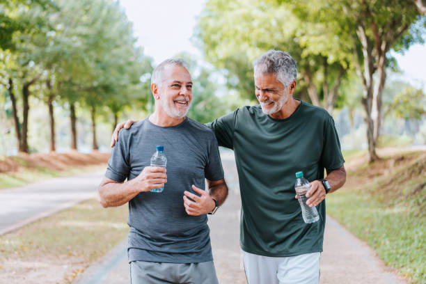 istock Senior friends walking in public park 1486145196