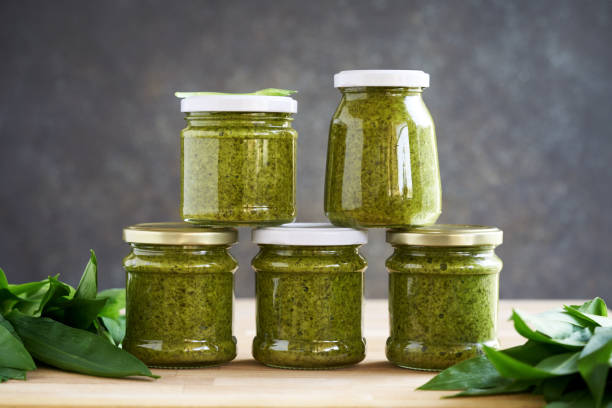 istock Bottled wild garlic pesto with fresh ramson leaves 1486147499