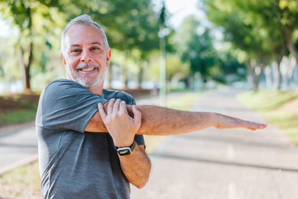 istock Senior man doing stretching in public park 1486147705