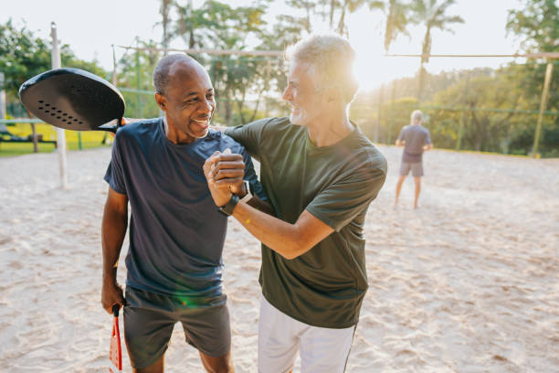 istock Two senior friends playing beach tennis 1486147804