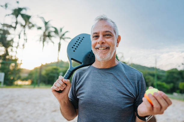 istock Senior man playing beach tennis looking at camera 1486148141