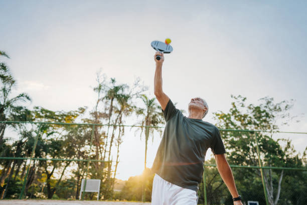 istock Senior man playing beach tennis 1486148792