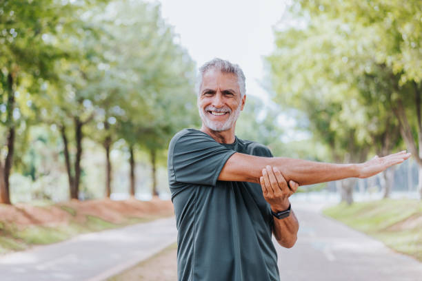 istock Senior man doing stretching in public park 1486148853